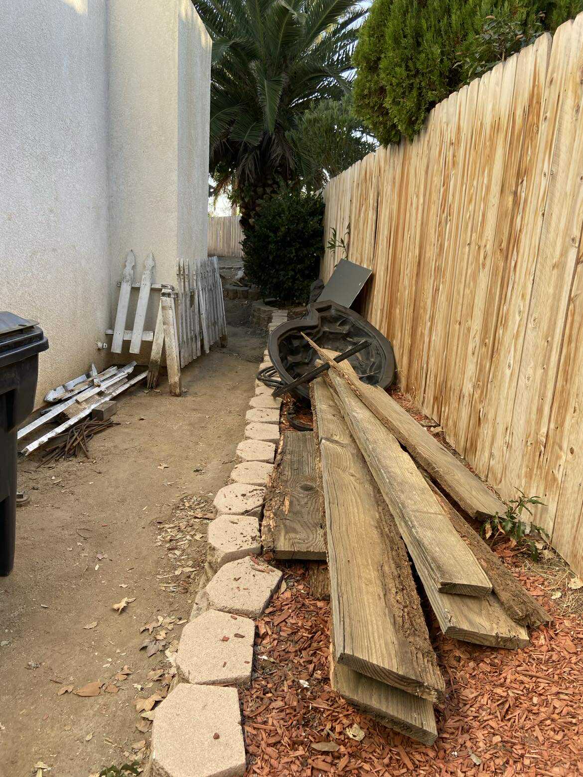 Fence removal with wood posts and boards in Murrieta side yard